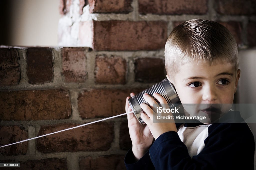 Your Next Mission A young boy receives his next mission via tin can phone.  Telephone Stock Photo