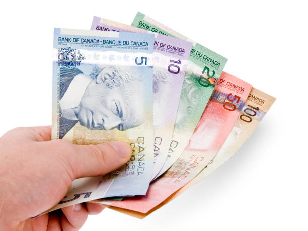 istock Canadian Currency in Hand (w/ clipping path) 157188747