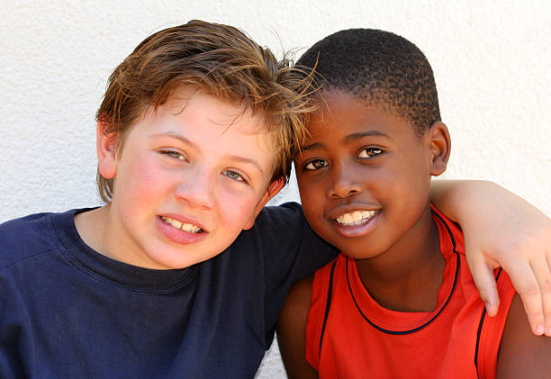 Two seven year old boys display their friendship for one another.