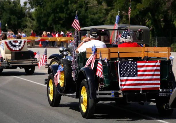 This patriotic retired couple drove their beautifully preserved antique car in a local Fourth of July parade.