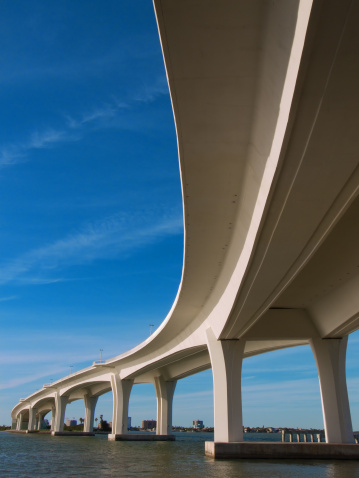 View from under the curved Bridge Overpass that goes over the water. Wide-angle lens provides an interesting perspective.