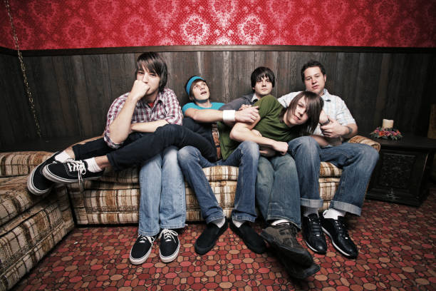istock Group of Guys Relaxing in Retro Couch Room 157189235