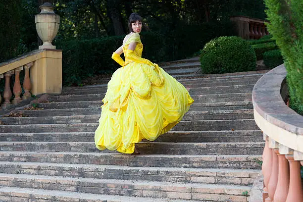 beautiful young girl,yellow dress lost her shoe walking up stairs, fairy-tale concept