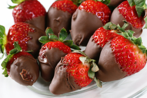 Close-up of strawberries covered with white and dark chocolate