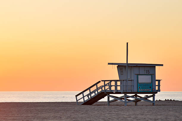 Lifeguard station at the empty beach during sunset stock photo