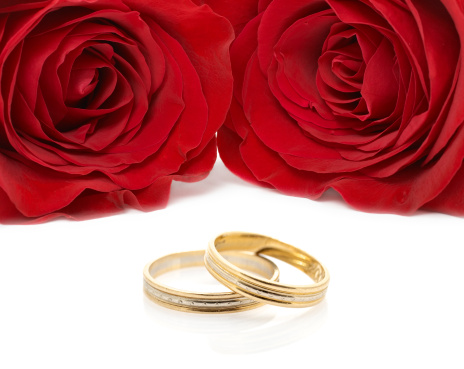 Two roses close-up and wedding ring