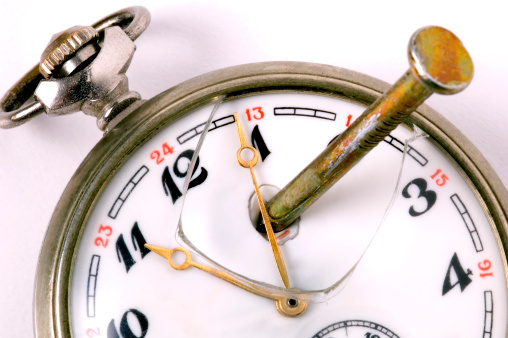 Old beautiful pocket watch lying in the beach sand.