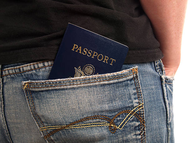 World Traveler Passport in man's back pocket -- ready to head out of the country for an adventure jeans denim passport pocket stock pictures, royalty-free photos & images