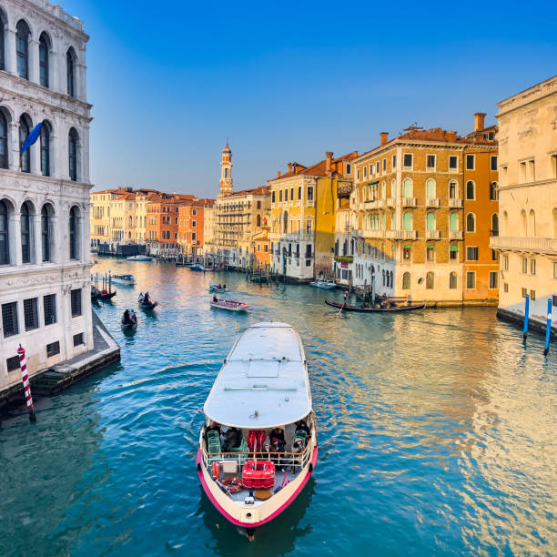 Vapuretta driving on Venice's Grand Canal Venice, Italy, 01/30/2023; The view from the Rialto Bridge on the Grand Canal Venice with Gondolas, Vaperetto's and water taxis creating a busy scene." venice italy grand canal honeymoon gondola stock pictures, royalty-free photos & images
