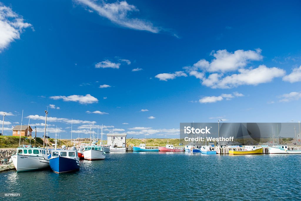 Fishing boats on the sea on a cloudy day Fishing boats rest safely in Plesant Bay harbor on Cape Breton Island Nova Scotia Stock Photo