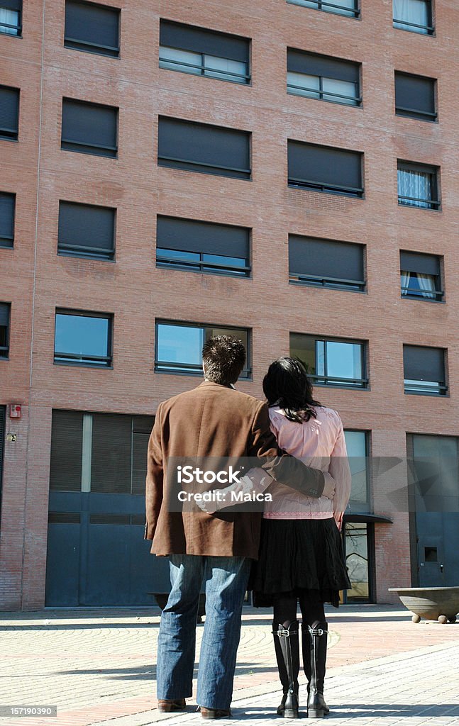 Planning Young couple looking an appartment building. A concept for home ownership. Couple - Relationship Stock Photo