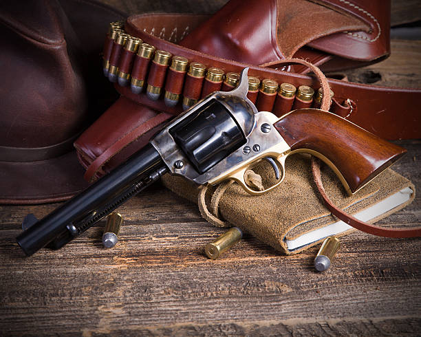 An old hand holding an antique revolver in a shooting position