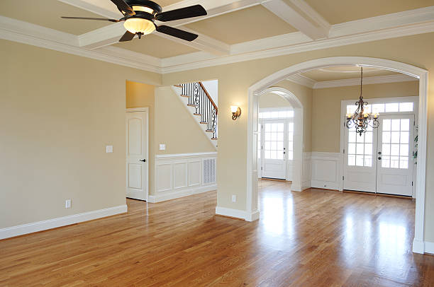Empty large room with shiny wooden floor and clean walls