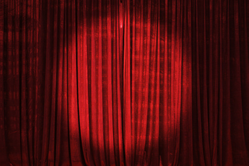 Bright spotlight on the stage curtain.