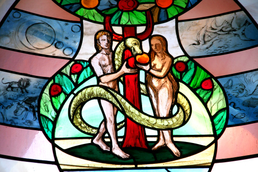 colorful church window with adam and eve