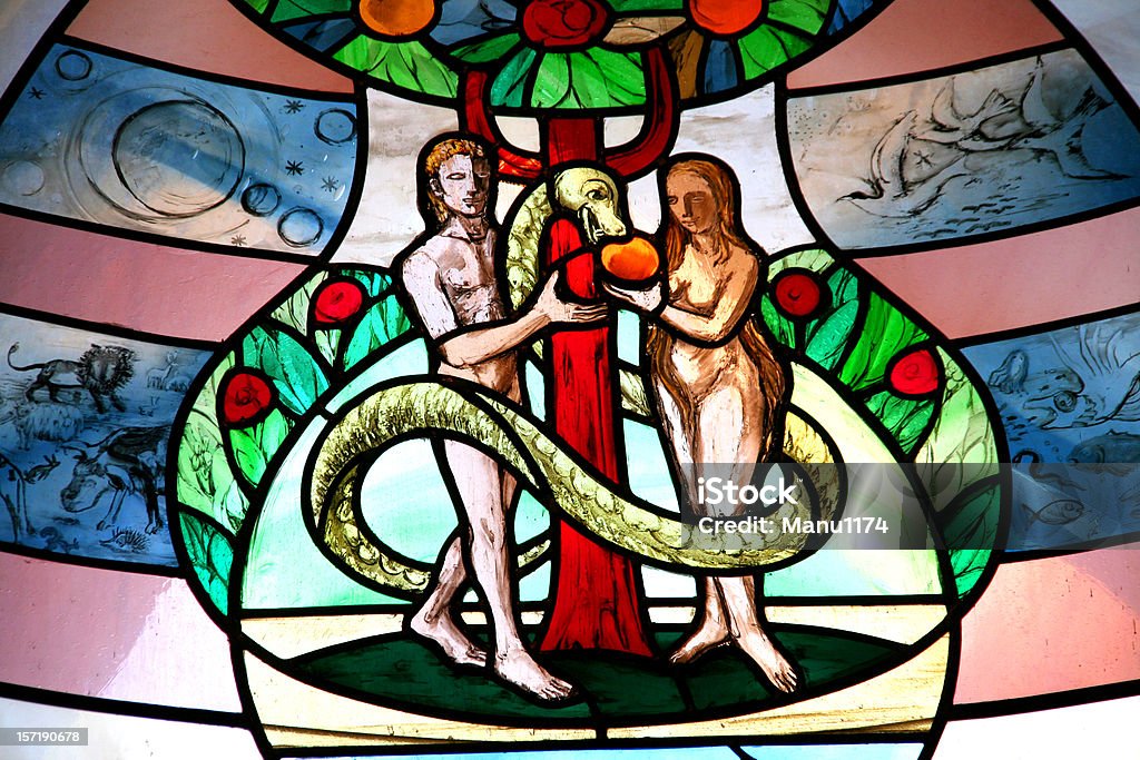 colorful church window with adam and eve church window,adam and eve unter the tree with snake Eve - Biblical Figure Stock Photo