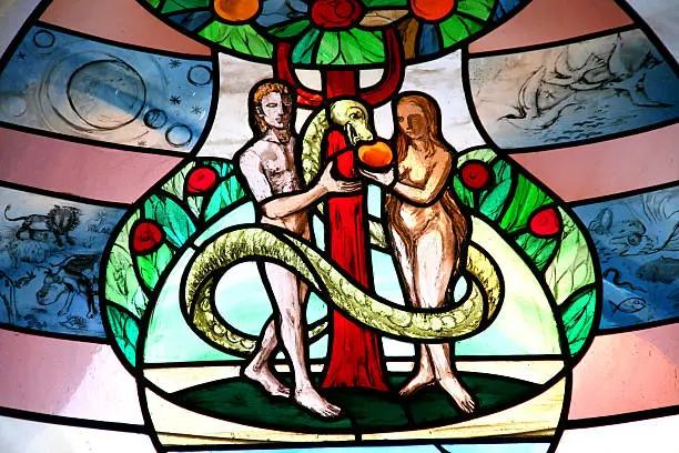church window,adam and eve unter the tree with snake