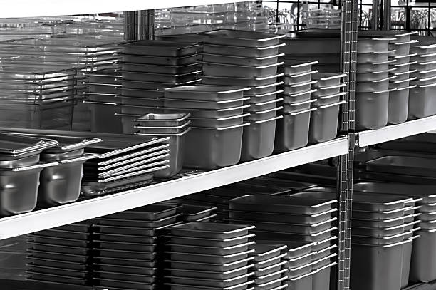 Several stacks of stainless steel pans stock photo