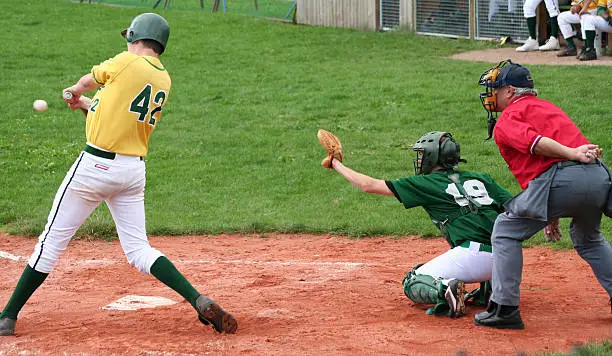 Photo of baseball player is hitting the ball