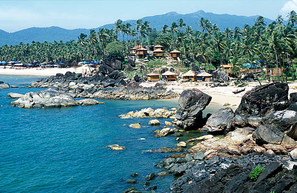 Tropical bay, Palolem beach, bamboo huts, palm trees, Goa, India Tropical bay, Palolem beach, white sand, bamboo huts, palm trees, rocks, mountains, Goa, India. palolem beach stock pictures, royalty-free photos & images