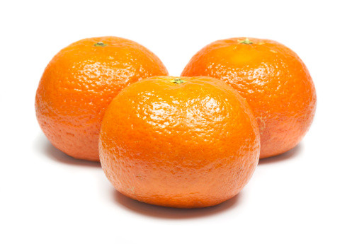 Fresh juicy tangerines on plate (isolated).