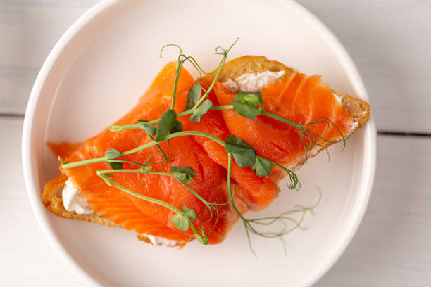 istock Sandwich with red fish and pea sprouts 1571910556