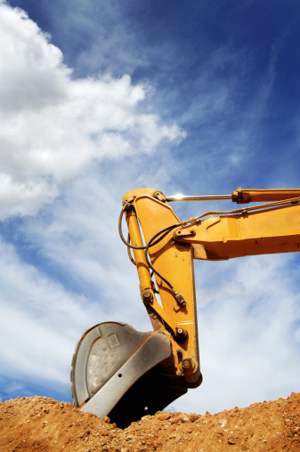 Excavator shovel removing soil