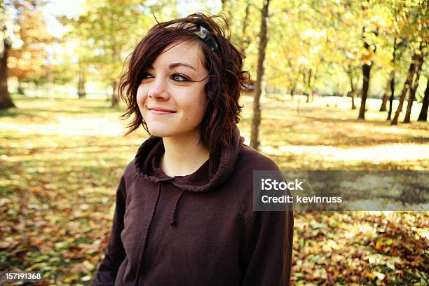 Smug Young Brunette Girl In The Park Stock Photo - Download Image Now - Adult, Autumn, Beautiful Woman