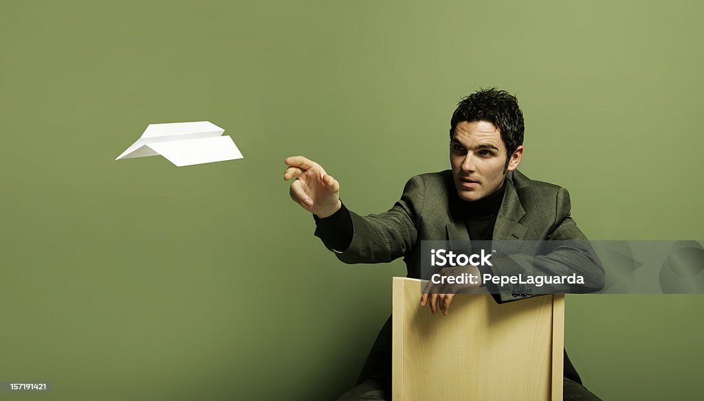 Ideas fly Young businessman flying a paper plane. 20-24 Years Stock Photo