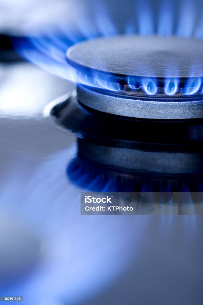 Blue flames from burner Blue flames from gas stove burner. Closeup shot of blue flames from a kitchen gas range. Natural Gas Stock Photo