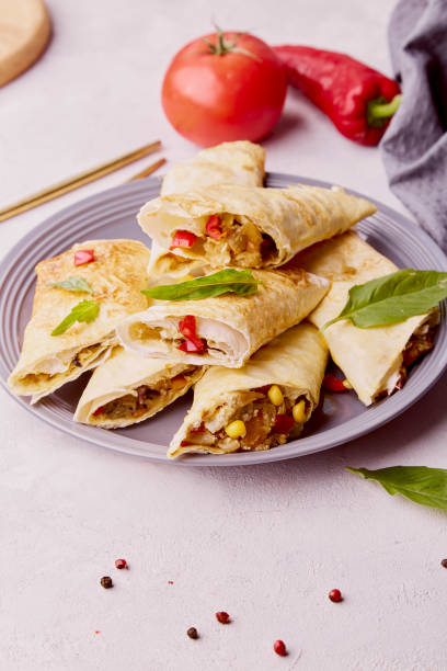 istock Vegetarian Southwest Egg Rolls combination of corn, black beans, red bell peppers, jalapenos with sweet and spicy seasoning in an egg roll wrapper. Alternative food 1571916930