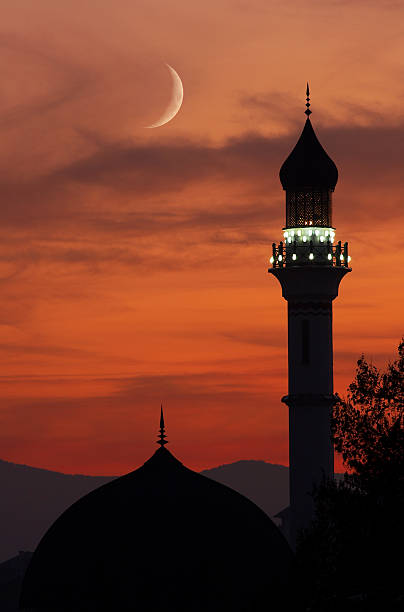 Photo of Mosque with crescent moon at dusk
