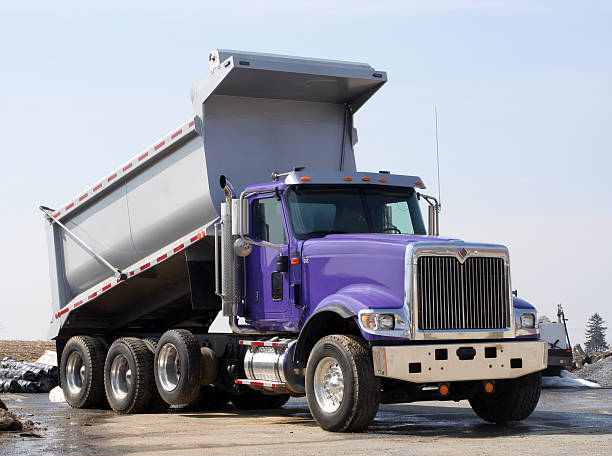 Dump Truck is Purple and Silver This purple dump truck has a purple cab and a silver dump area. It looks brand new.   dump truck photos stock pictures, royalty-free photos & images