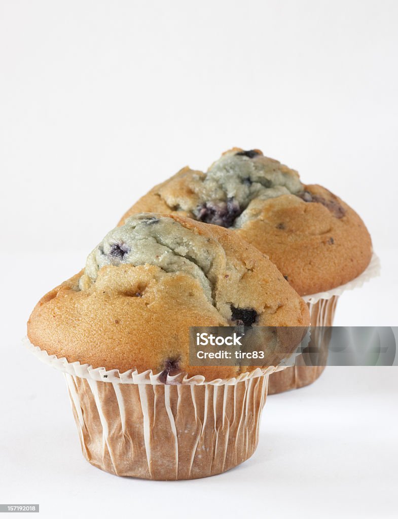 Blueberry muffins Two blueberry muffins on a light background Blueberry Muffin Stock Photo