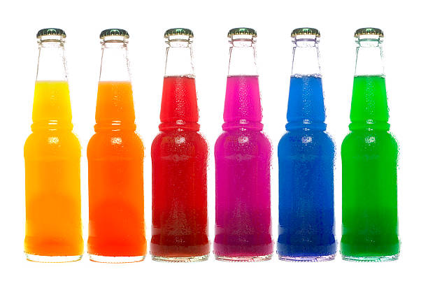 Row of multi coloured bottle of drink on white stock photo