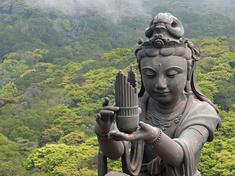 big Buddha at Lantau Island / Hong Kong is looking at this statue providing offerings,