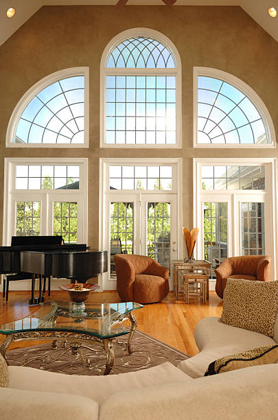 Home Interior with large windows Large, expansive windows in this luxury home. expensive grand piano stock pictures, royalty-free photos & images