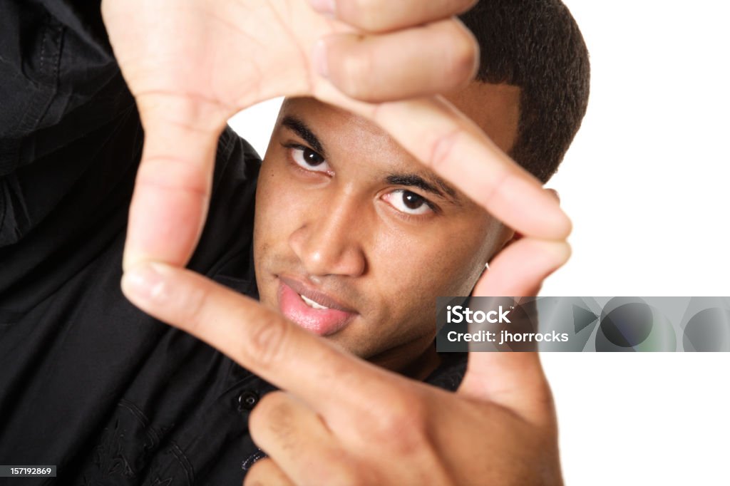 Framed Photo of a young man looking through a frame formed by his hands. 20-29 Years Stock Photo