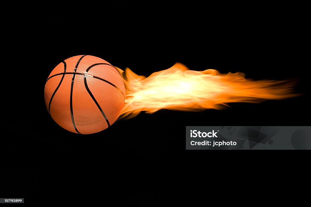 A burning basketball flying through the air basketball on fire to denote speed and power Speed Stock Photo