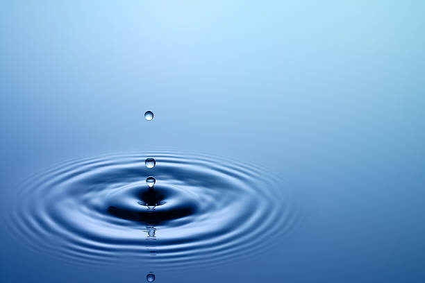 Drops of water bouncing off the surface stock photo