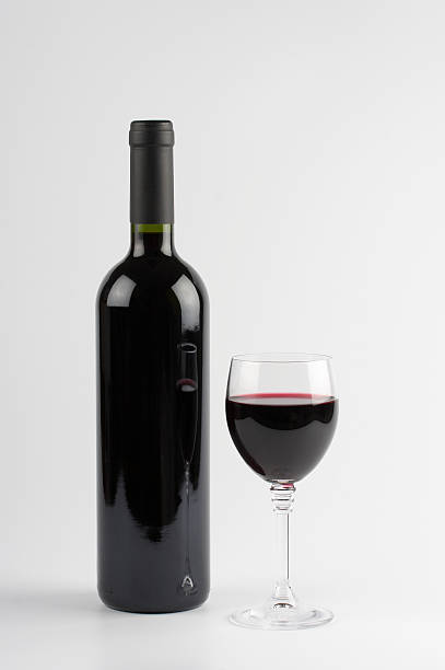 istock Red wine bottle and glass, isolated on white background 157193202