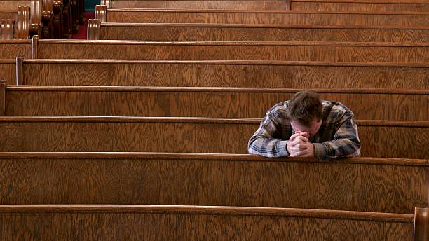 beten in der kirche - praying men god kneeling stock-fotos und bilder