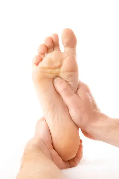 massage of one foot on white background