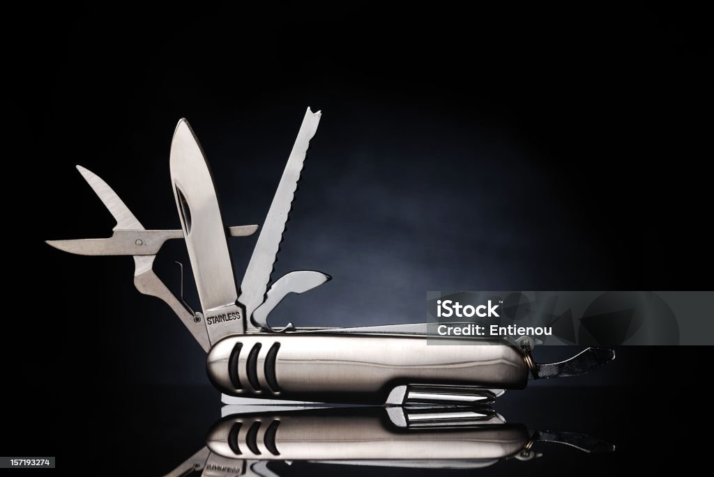 Isolated gray pocket knife with its tools extended All purpose silver pocket knife. Penknife Stock Photo