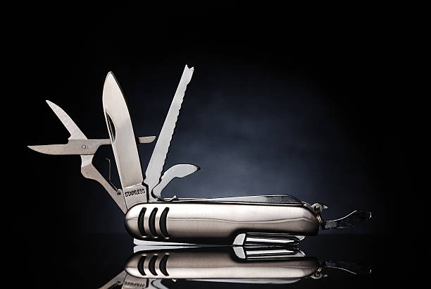 Isolated gray pocket knife with its tools extended stock photo