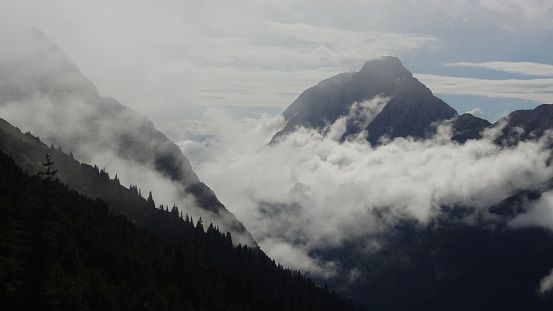 Low hanging clouds in the early morning hours upto the Zugspitze, Germany. Hike from Austrian side