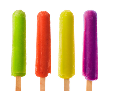 Subject: Four different color and flavors popsicles against a white background