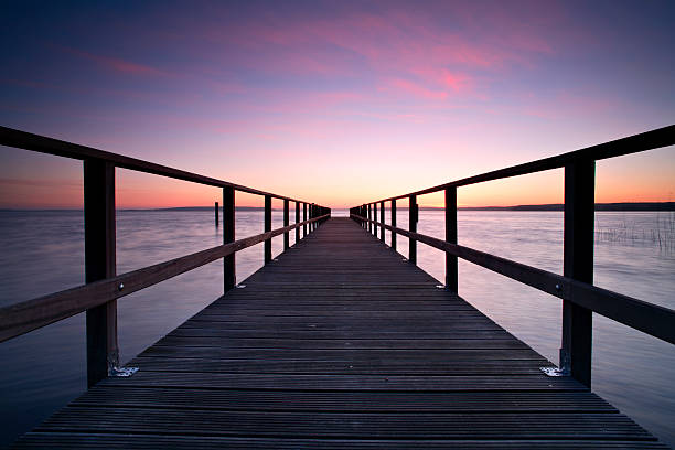 istock Long Wooden Dock and Lake at Sunrise 157193645