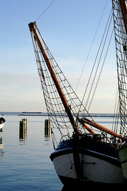Dutch fishing boat tied up in harbour on a clear day at Hoorn in the Netherlands. 