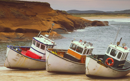 Meteghan, Nova Scotia, Canada - February 26, 2022: Commercial fishing boats in the harbour in Meteghan, Nova Scotia. Meteghan is an active fishing port on the French Shore of Clare County. The area is steeped in Acadian history and culture and it's connection to the sea.